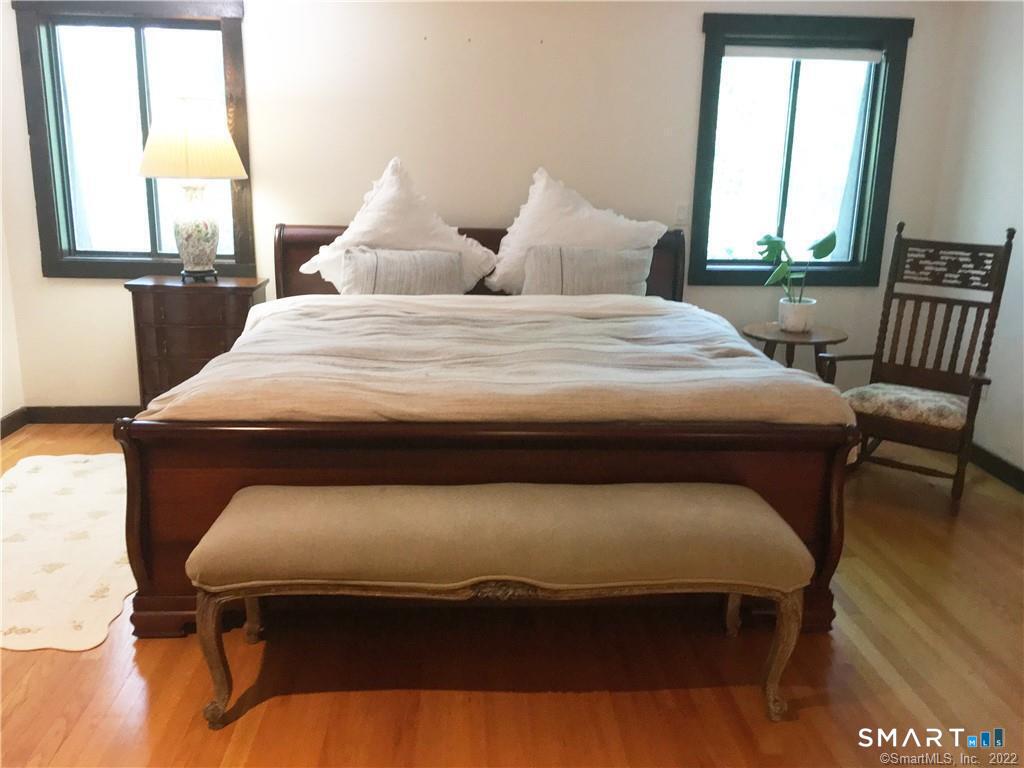 36 Lyons Plain Road Westport, CT 06880 - Photo 8 of 9 a bedroom with a bed and wooden floor
