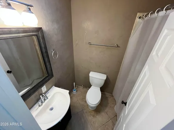 a bathroom with a sink a toilet a mirror and vanity