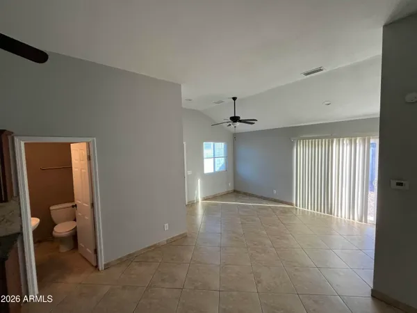 a view of a livingroom with a ceiling fan and window