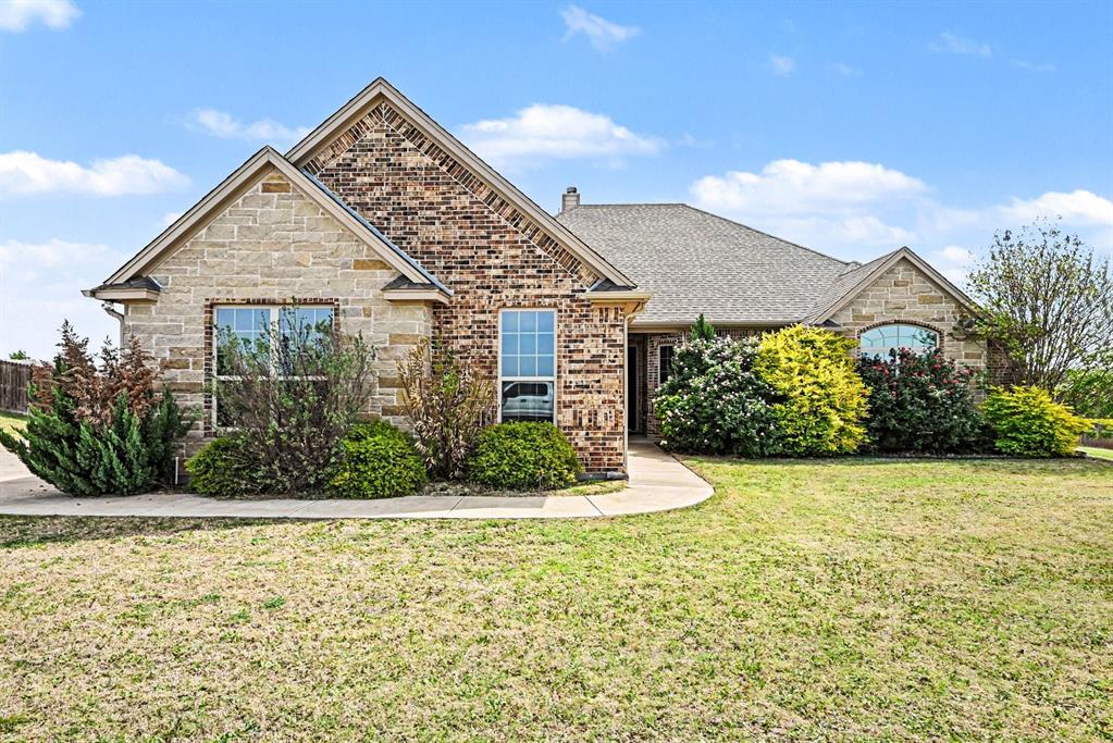 104 Stanford Lane Springtown, TX 76082 - Photo 1 of 28 a view of a house with a yard and potted plants