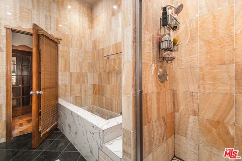 a living room with furniture a mirror and a wooden floor