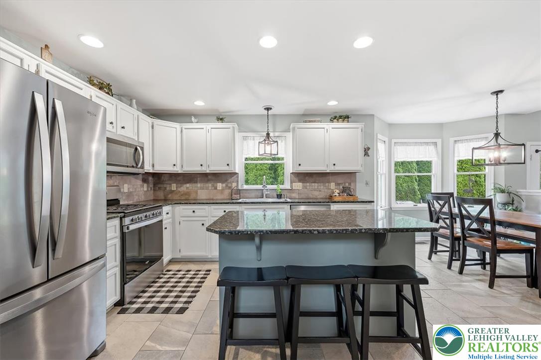 2011 Fieldview Drive Nazareth, PA 18064 - Photo 6 of 52 A sleek, contemporary kitchen with white cabinetry and granite countertops.