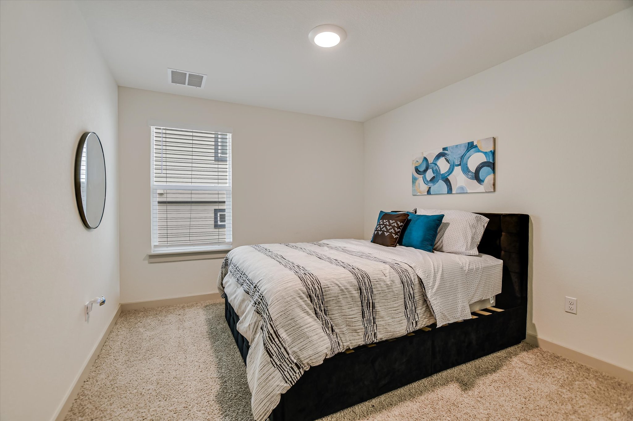 105 Merrick Road Georgetown, TX 78628 - Photo 12 of 23 Well-lit and tranquil, this bedroom provides a peaceful retreat with plush carpet and a wide window.