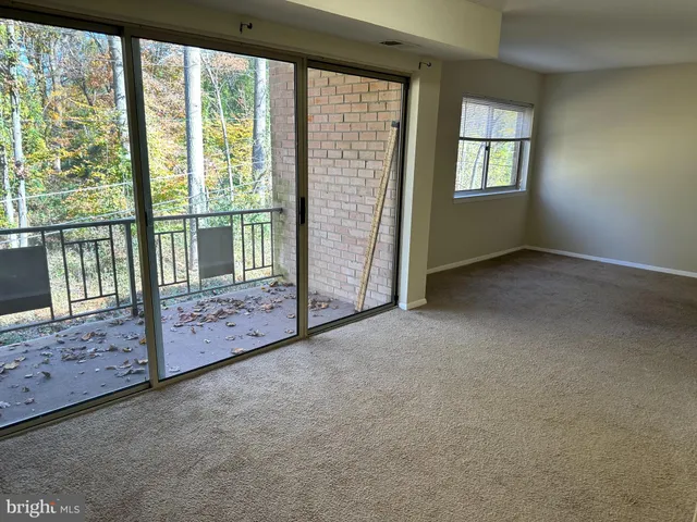 a view of an empty room with windows