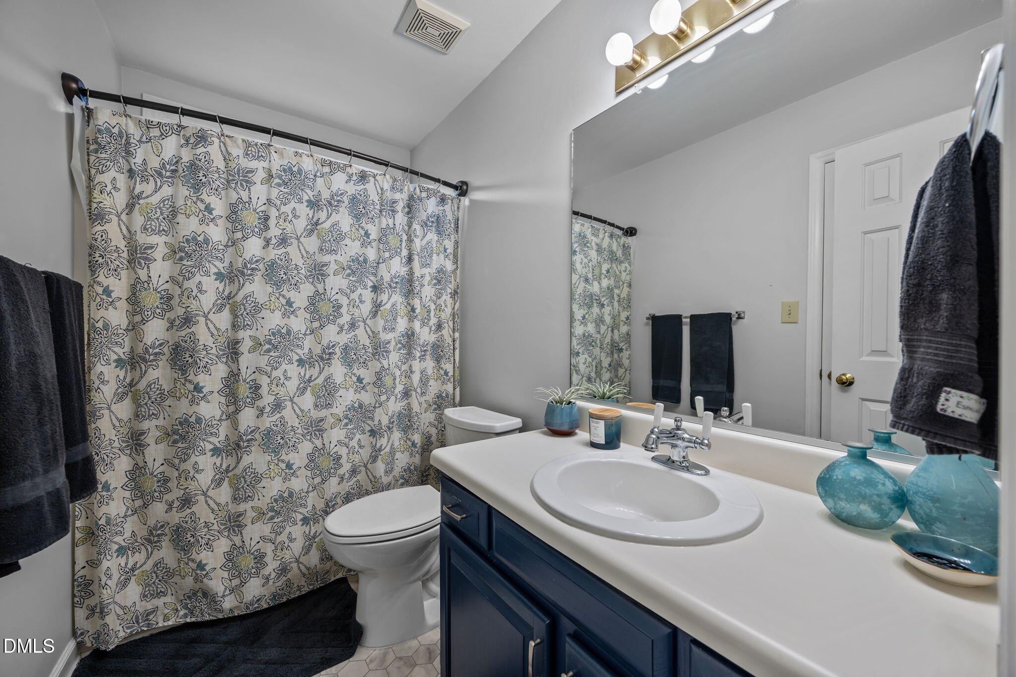 4952 Liverpool Lane Raleigh, NC 27604 - Photo 15 of 44 a bathroom with a sink toilet and mirror