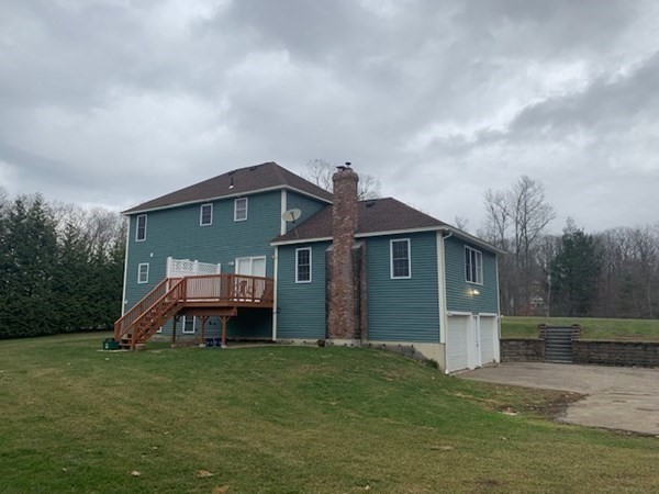 155 Barre Paxton Road Rutland, MA 01543 - Photo 3 of 42 a front view of a house with a garden and trees