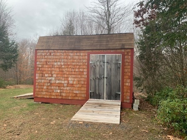 155 Barre Paxton Road Rutland, MA 01543 - Photo 7 of 42 a brick house with a outdoor space