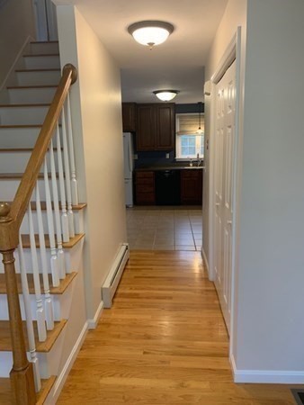 155 Barre Paxton Road Rutland, MA 01543 - Photo 8 of 42 a view of a hallway with wooden floor and kitchen