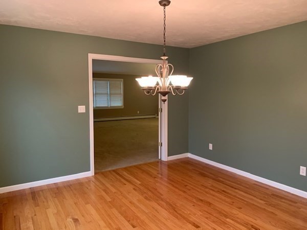 155 Barre Paxton Road Rutland, MA 01543 - Photo 10 of 42 a view of a room with a chandelier fan and wooden floor