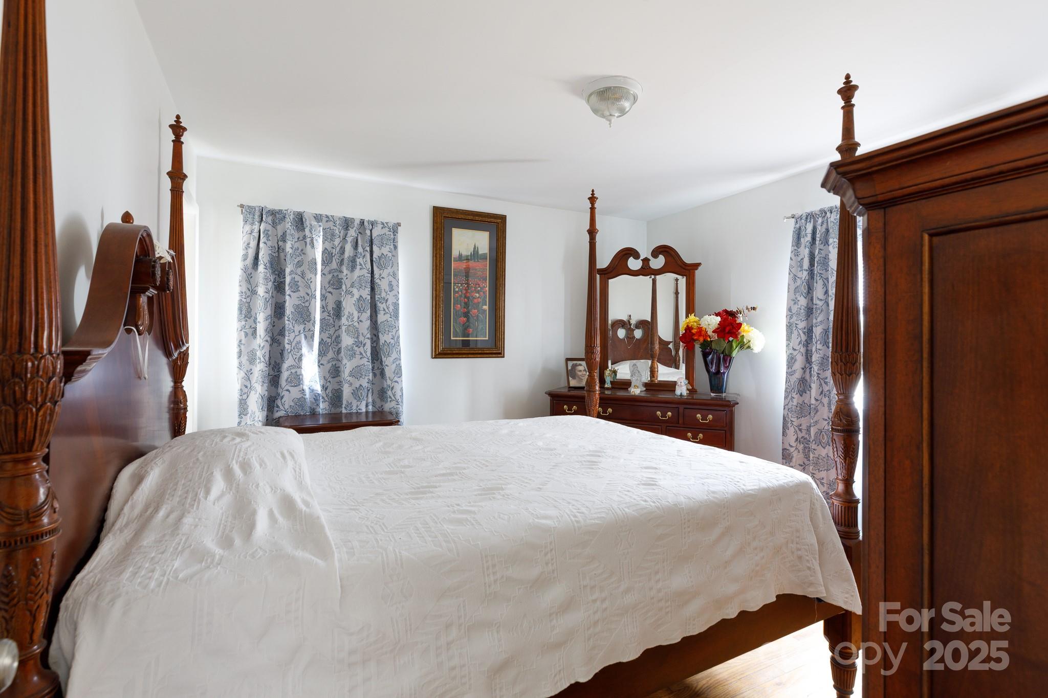 103 Perry Street Shelby, NC 28150 - Photo 11 of 22 a bed room with a bed and a mirror