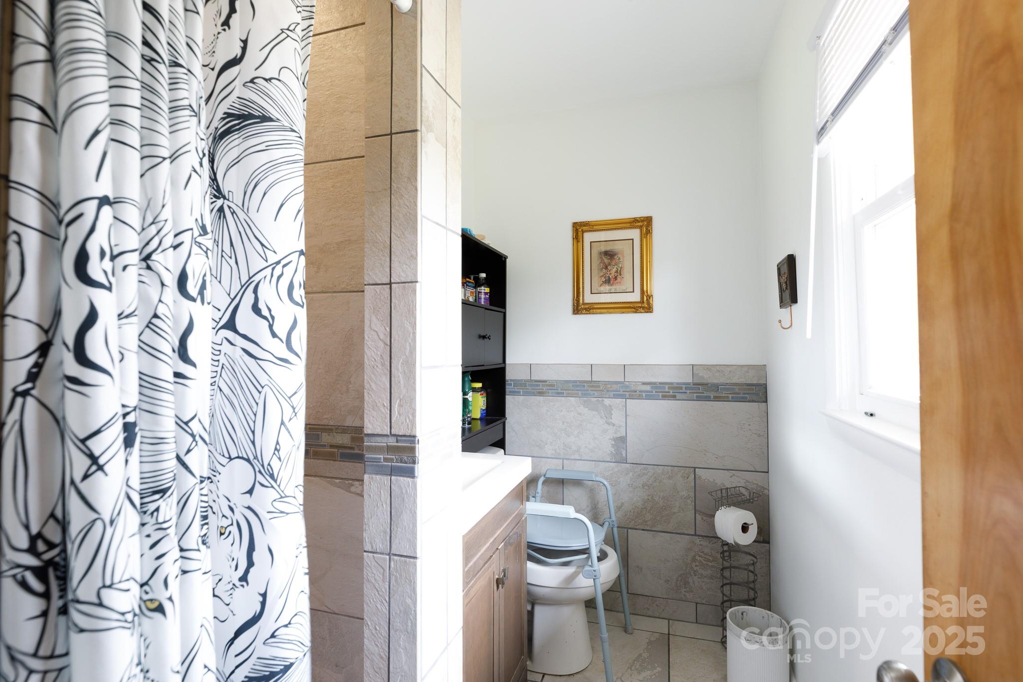 103 Perry Street Shelby, NC 28150 - Photo 12 of 22 a bathroom with a toilet and a shower curtain