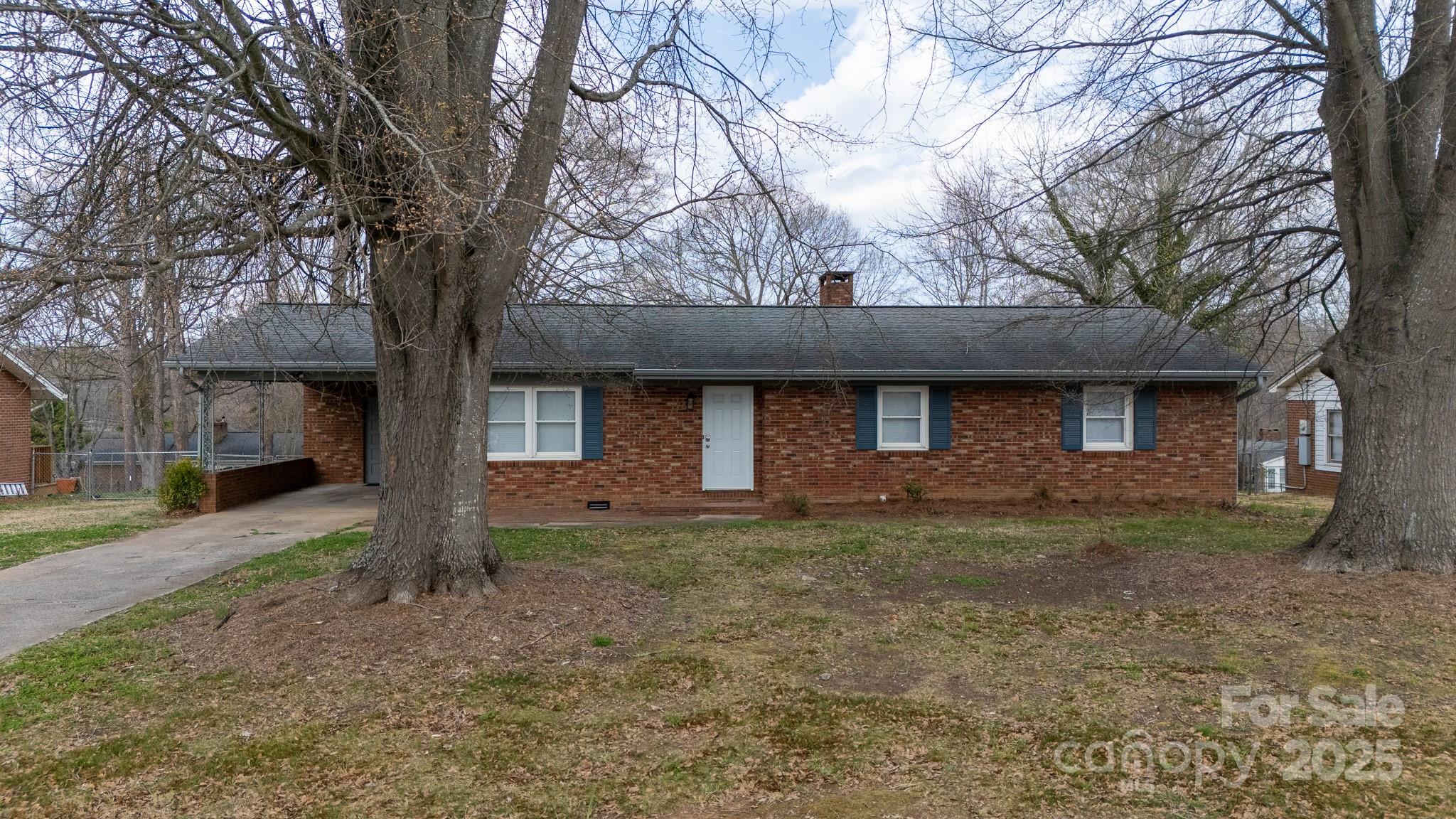 103 Perry Street Shelby, NC 28150 - Photo 2 of 22 a front view of a house with garden