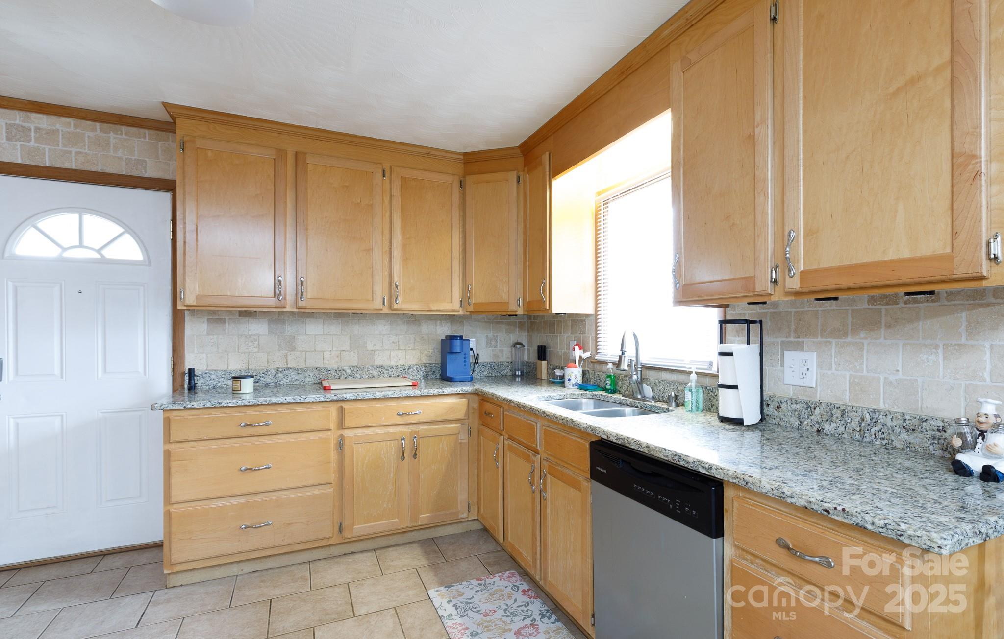 103 Perry Street Shelby, NC 28150 - Photo 3 of 22 a kitchen with stainless steel appliances granite countertop white cabinets sink and window