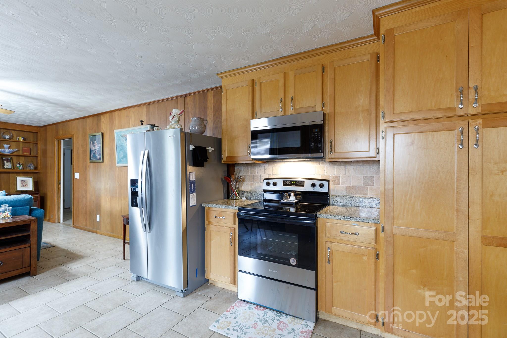 103 Perry Street Shelby, NC 28150 - Photo 5 of 22 a kitchen with stainless steel appliances granite countertop a refrigerator stove and sink