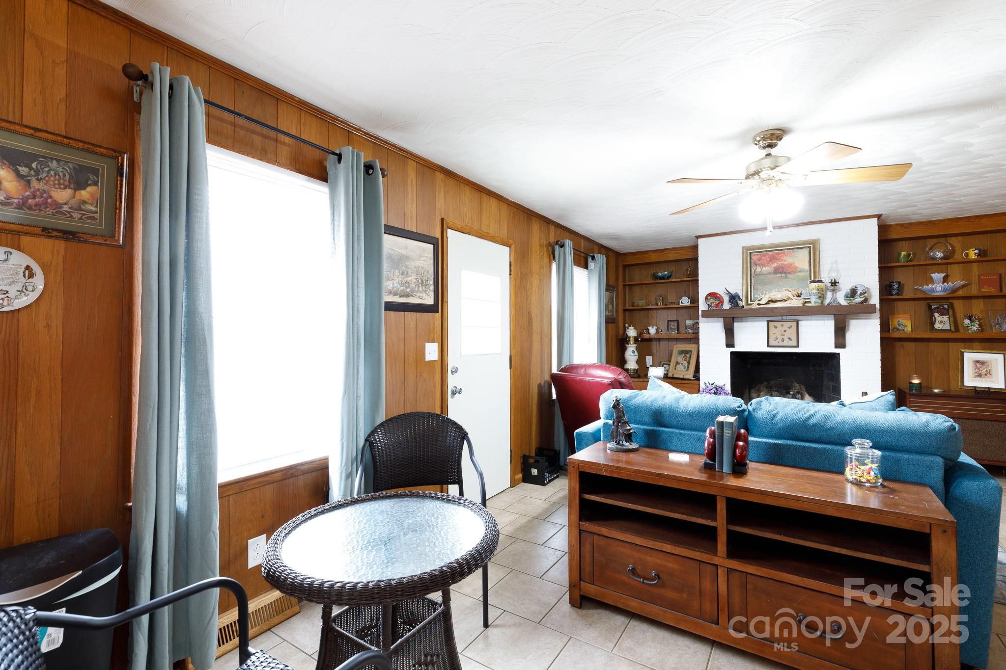 103 Perry Street Shelby, NC 28150 - Photo 6 of 22 a living room with furniture a fireplace and a chandelier