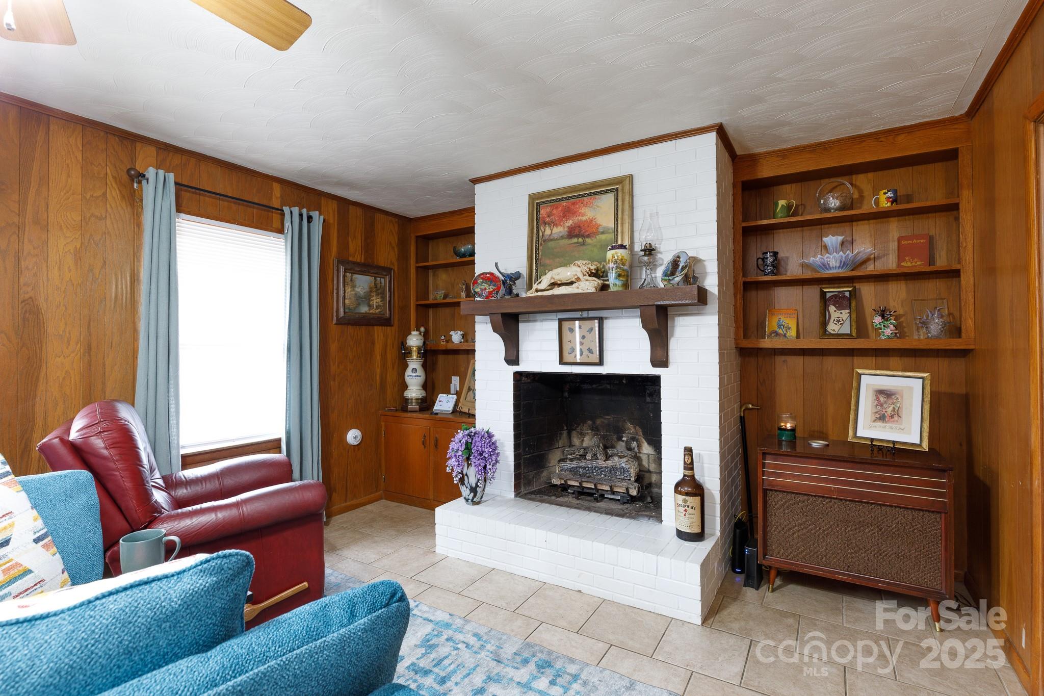 103 Perry Street Shelby, NC 28150 - Photo 8 of 22 a living room with furniture a flat screen tv and a fireplace