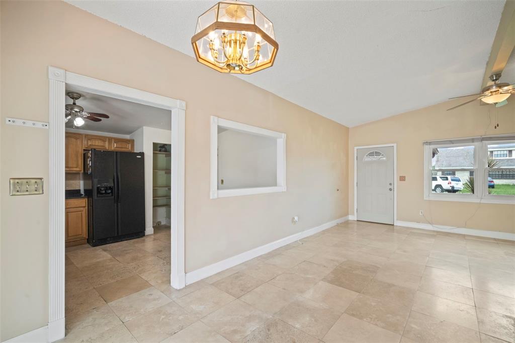 4712 Bessie Road Tampa, FL 33615 - Photo 12 of 28 an empty room with entrance and windows