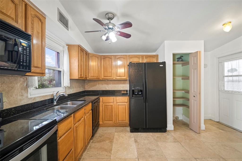 4712 Bessie Road Tampa, FL 33615 - Photo 13 of 28 a kitchen with stainless steel appliances granite countertop a refrigerator a sink and dishwasher