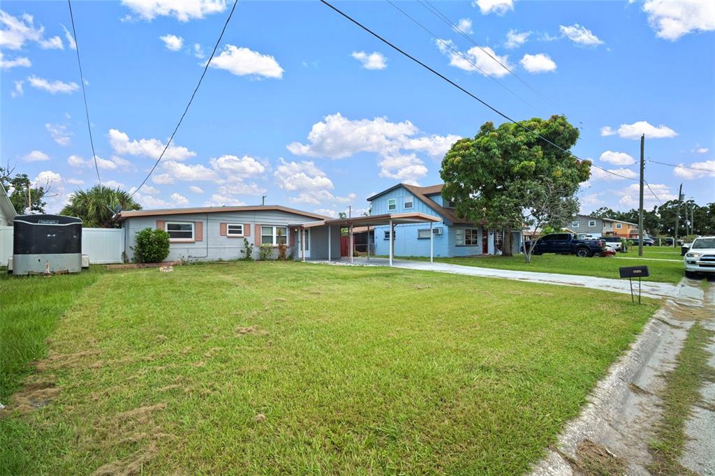 4712 Bessie Road Tampa, FL 33615 - Photo 18 of 28 a front view of a house with a yard