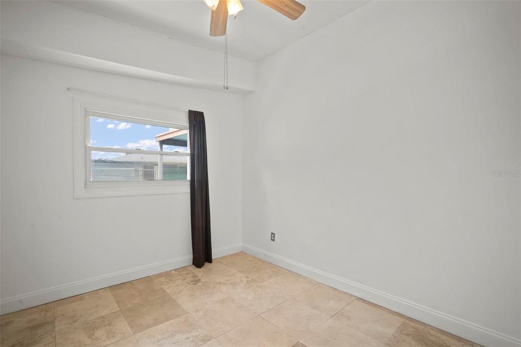 4712 Bessie Road Tampa, FL 33615 - Photo 20 of 28 an empty room with a window and outer view