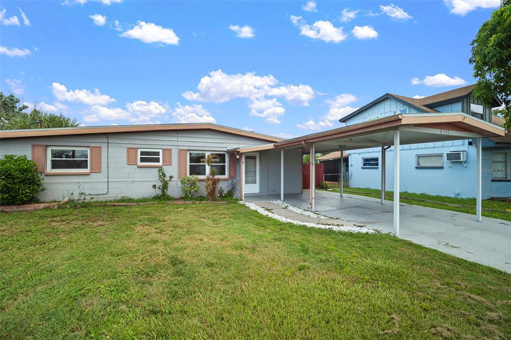 4712 Bessie Road Tampa, FL 33615 - Photo 2 of 28 a view of a house with a backyard