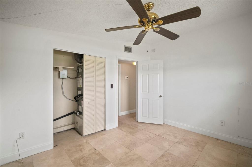 4712 Bessie Road Tampa, FL 33615 - Photo 24 of 28 an empty room with closet and ceiling fan