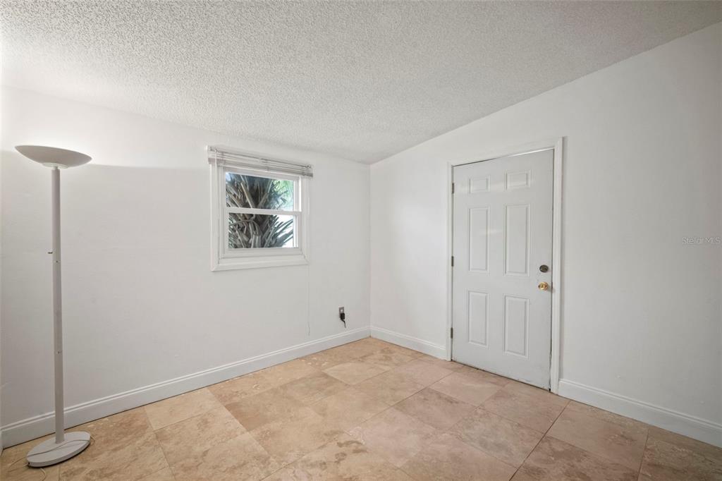 4712 Bessie Road Tampa, FL 33615 - Photo 25 of 28 an empty room with windows and closet