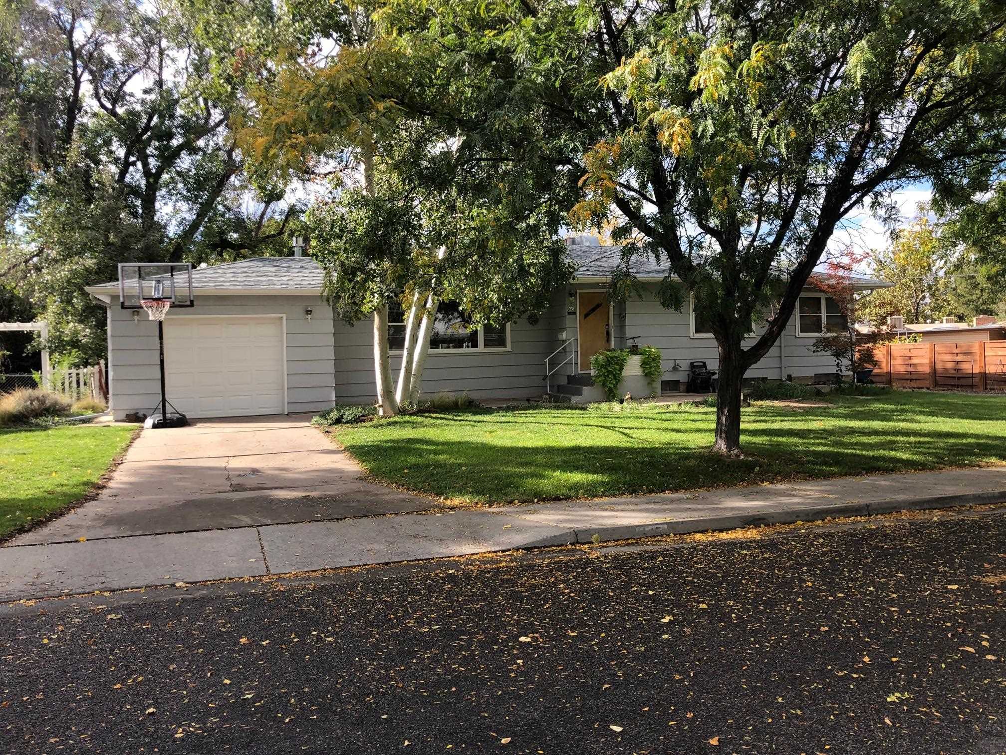 445 Hall Avenue Grand Junction, CO 81501 - Photo 1 of 23 a front view of a house with a yard and garage