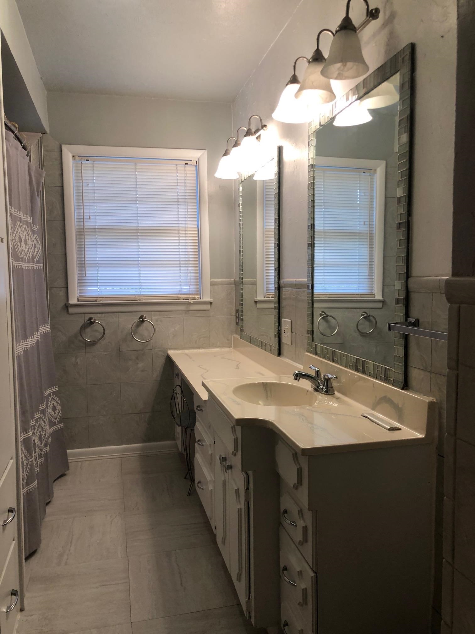 445 Hall Avenue Grand Junction, CO 81501 - Photo 17 of 23 a bathroom with a sink a vanity and a mirror