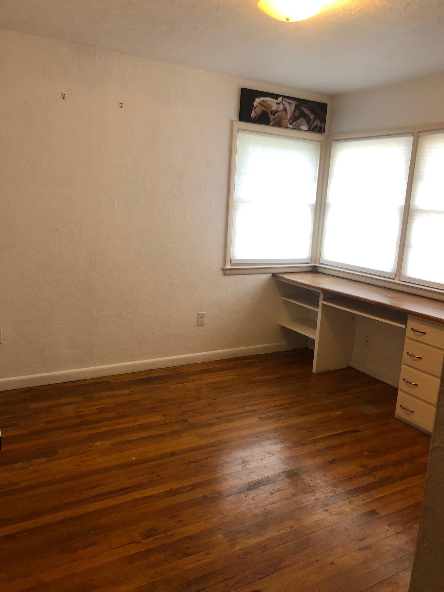 445 Hall Avenue Grand Junction, CO 81501 - Photo 18 of 23 a view of room with window and wooden floor