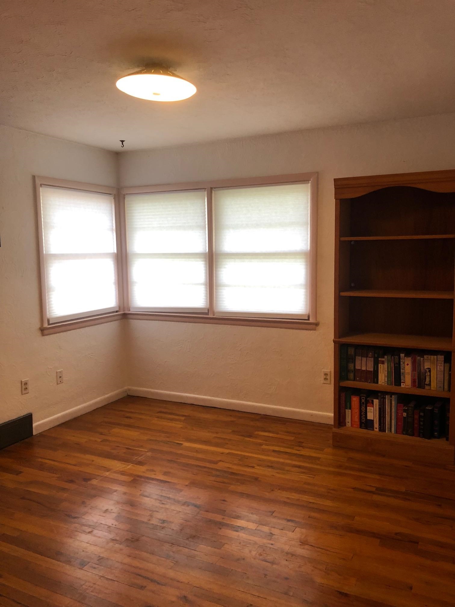 445 Hall Avenue Grand Junction, CO 81501 - Photo 19 of 23 an empty room with wooden floor and windows