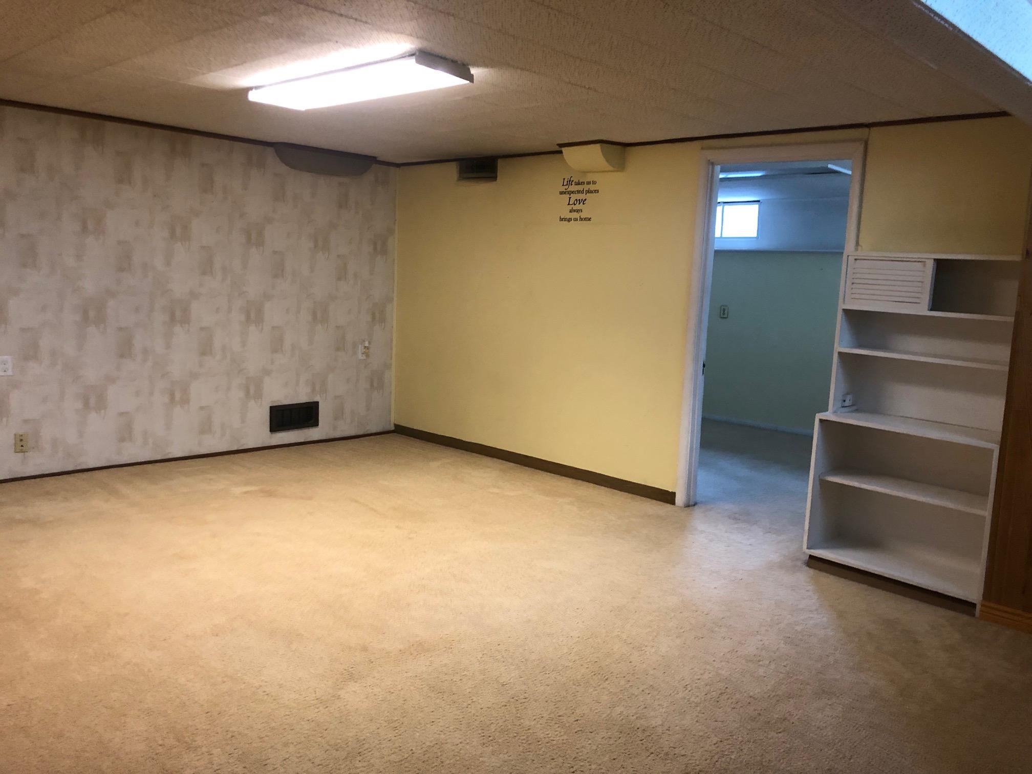 445 Hall Avenue Grand Junction, CO 81501 - Photo 20 of 23 an empty room with a furniture and a kitchen