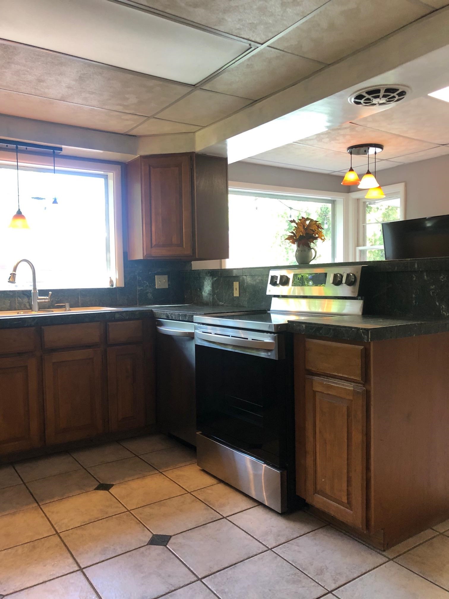 445 Hall Avenue Grand Junction, CO 81501 - Photo 7 of 23 a kitchen with a sink a stove top oven and cabinetry