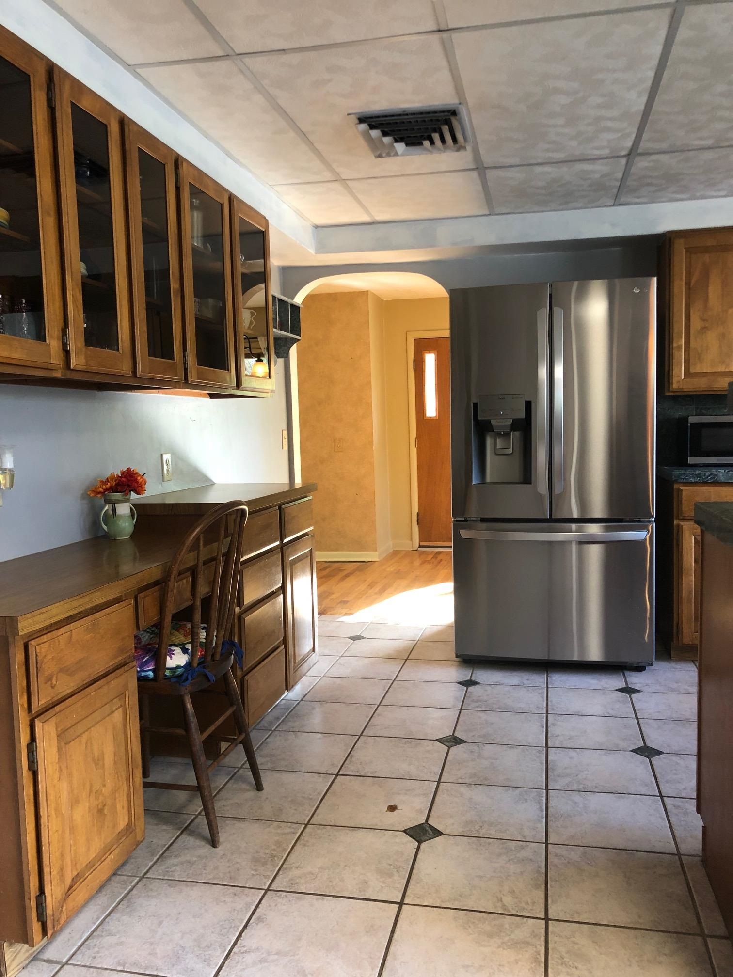 445 Hall Avenue Grand Junction, CO 81501 - Photo 8 of 23 a kitchen with granite countertop a refrigerator and a stove top oven