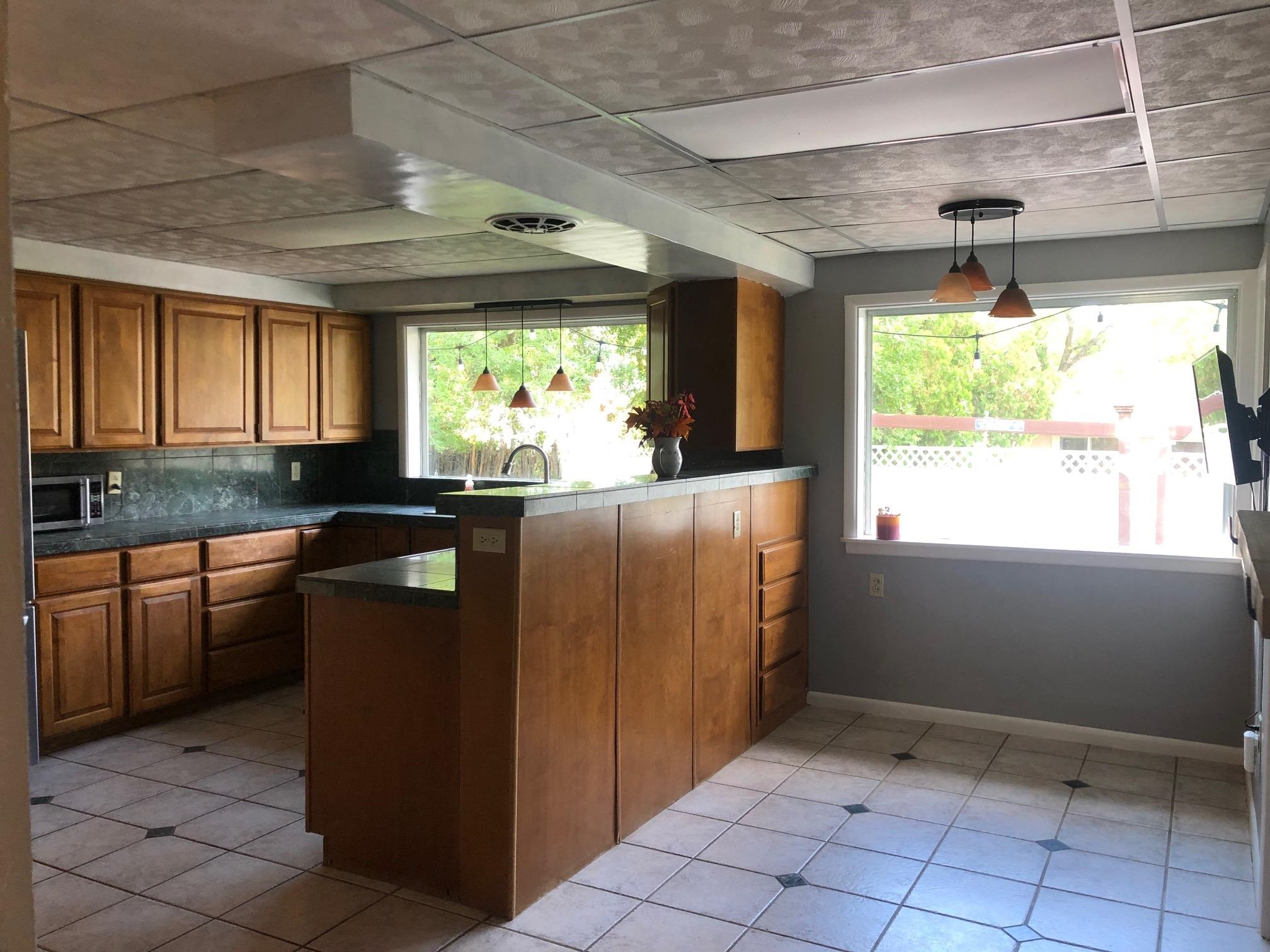 445 Hall Avenue Grand Junction, CO 81501 - Photo 9 of 23 a kitchen with kitchen island granite countertop a refrigerator and a sink