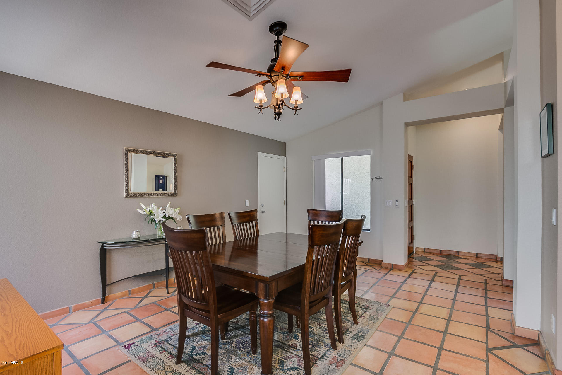 3623 East Agave Road Phoenix, AZ 85044 - Photo 8 of 41 a view of a dining room with furniture and chandelier