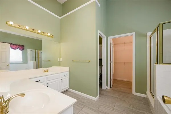 a en suite bathroom with a double vanity sink a mirror and a shower
