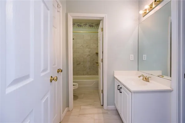 a bathroom with a sink a mirror and a shower