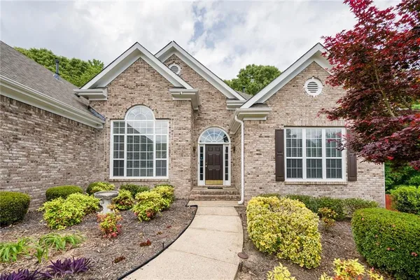 a front view of a house with a garden