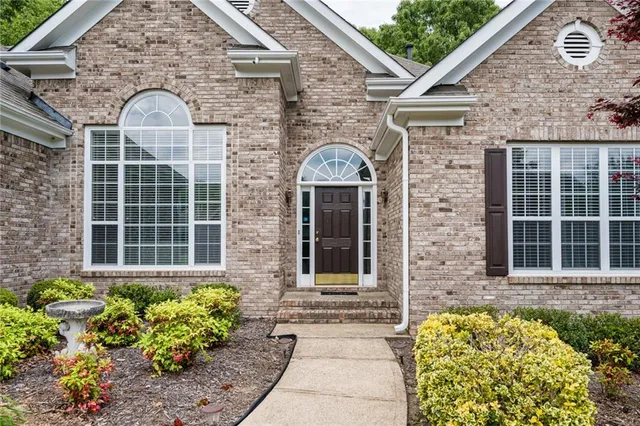 a front view of a house with a garden