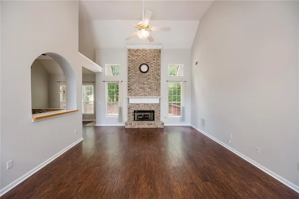 a view of livingroom with fireplace wooden floor and a chandelier