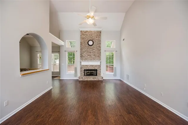 a view of livingroom with fireplace wooden floor and a chandelier
