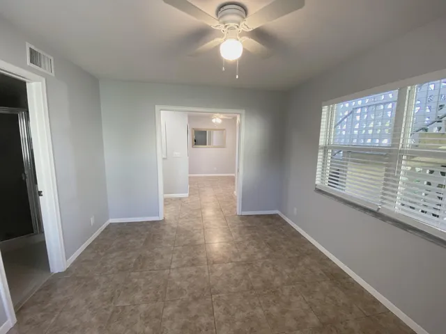 a bathroom with a shower sink vanity and mirror