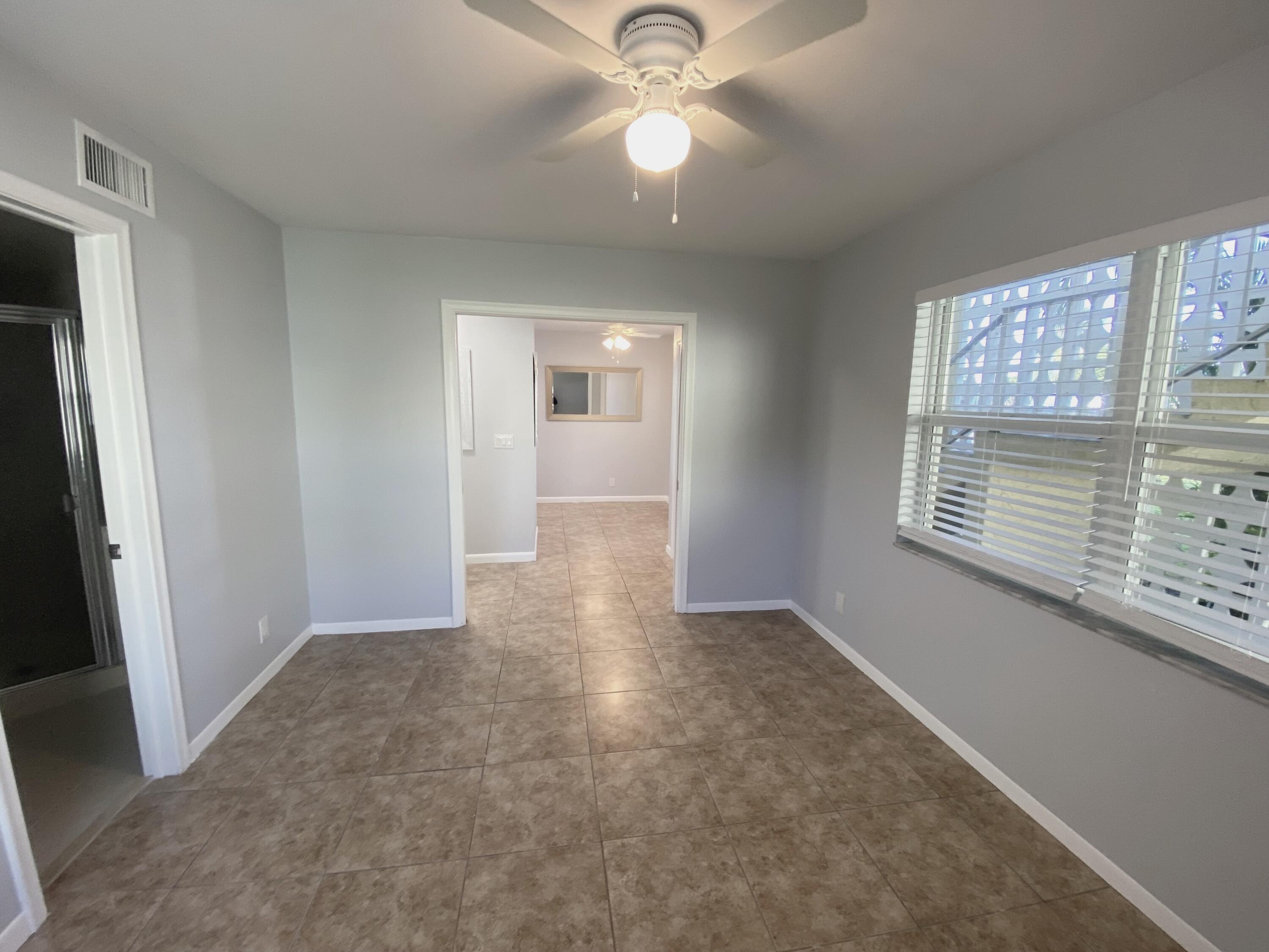 1100 Boxwood Drive, Unit 101 Delray Beach, FL 33445 - Photo 15 of 33 an empty room with fan and windows