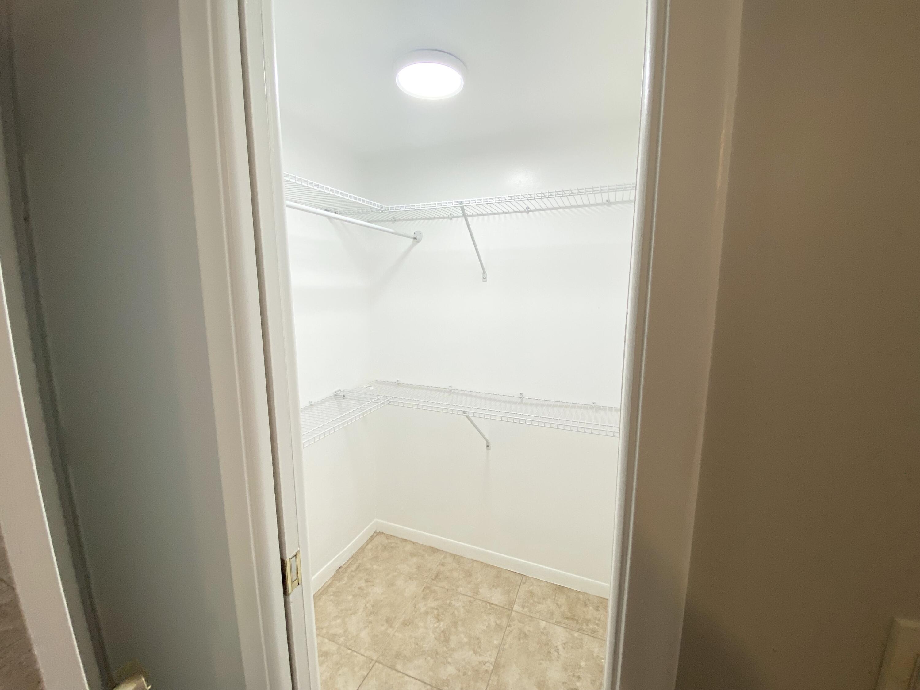 1100 Boxwood Drive, Unit 101 Delray Beach, FL 33445 - Photo 19 of 33 a view of walk in closet