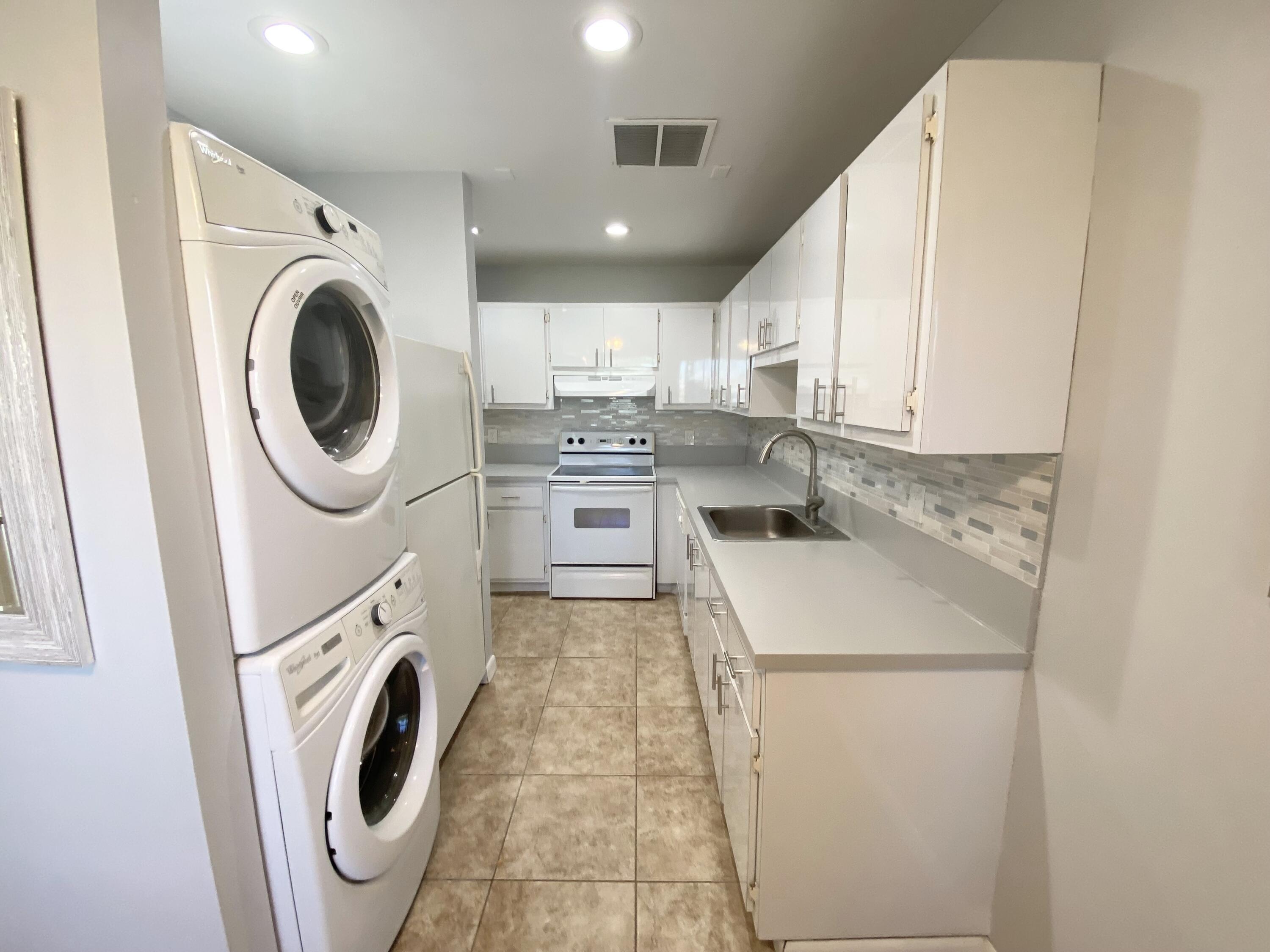1100 Boxwood Drive, Unit 101 Delray Beach, FL 33445 - Photo 21 of 33 a view of a kitchen with washer and dryer