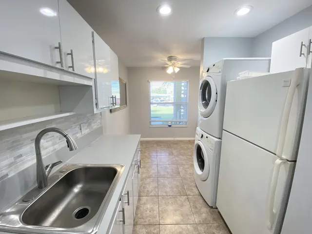 a kitchen with refrigerator and car