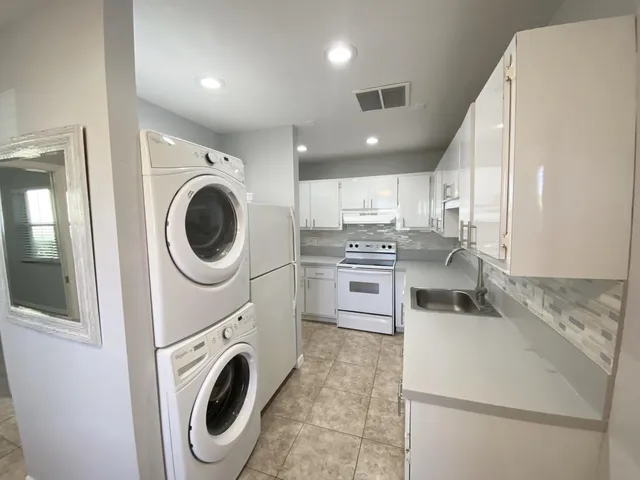 a kitchen with a washer and dryer