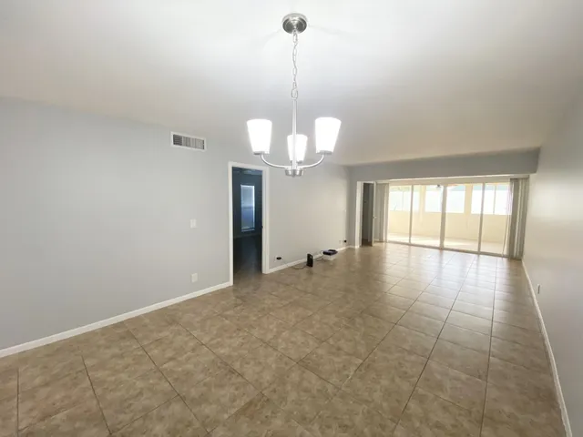 an empty room with fan and entrance