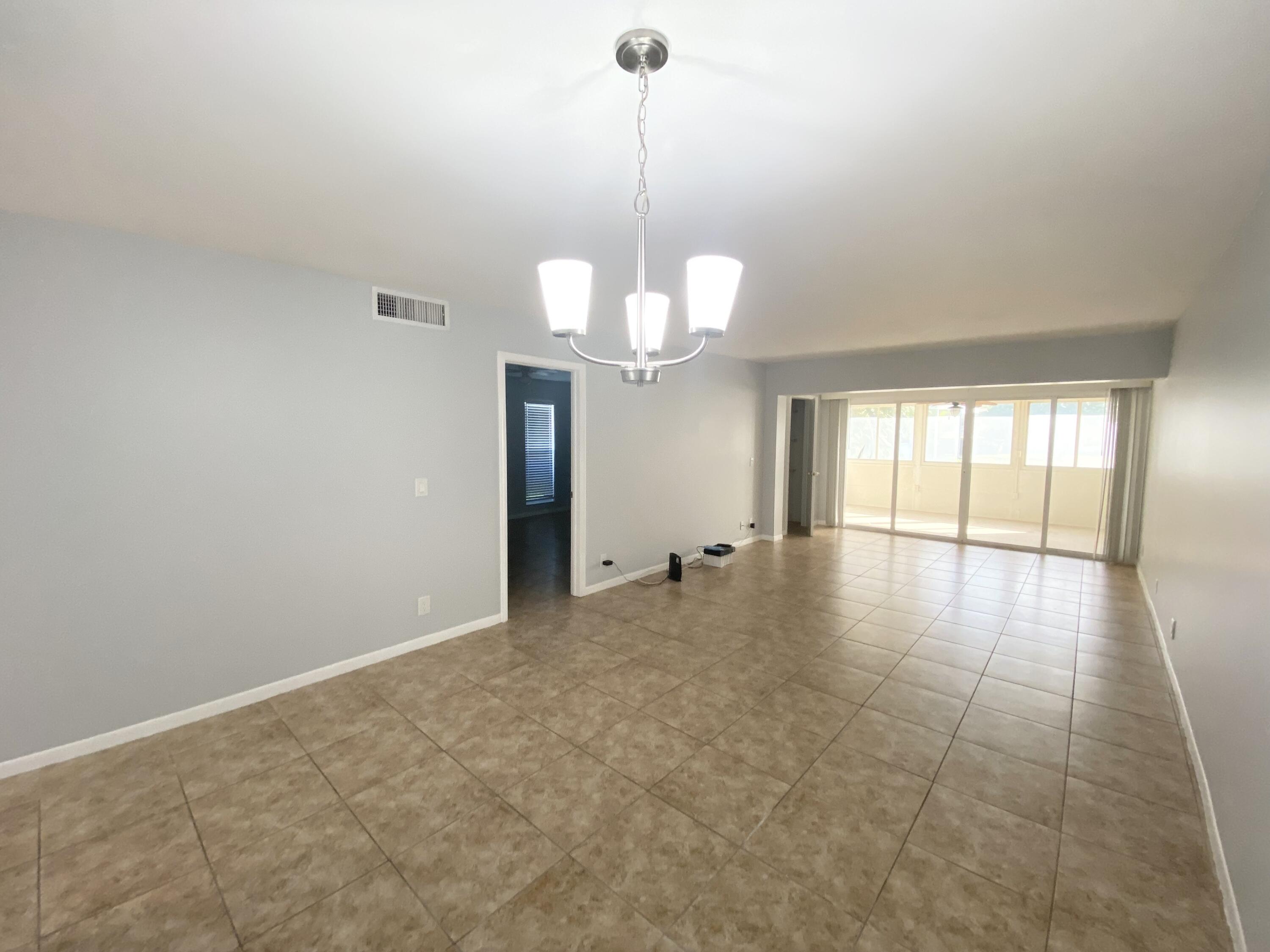 1100 Boxwood Drive, Unit 101 Delray Beach, FL 33445 - Photo 8 of 33 a view of a room with window and chandelier